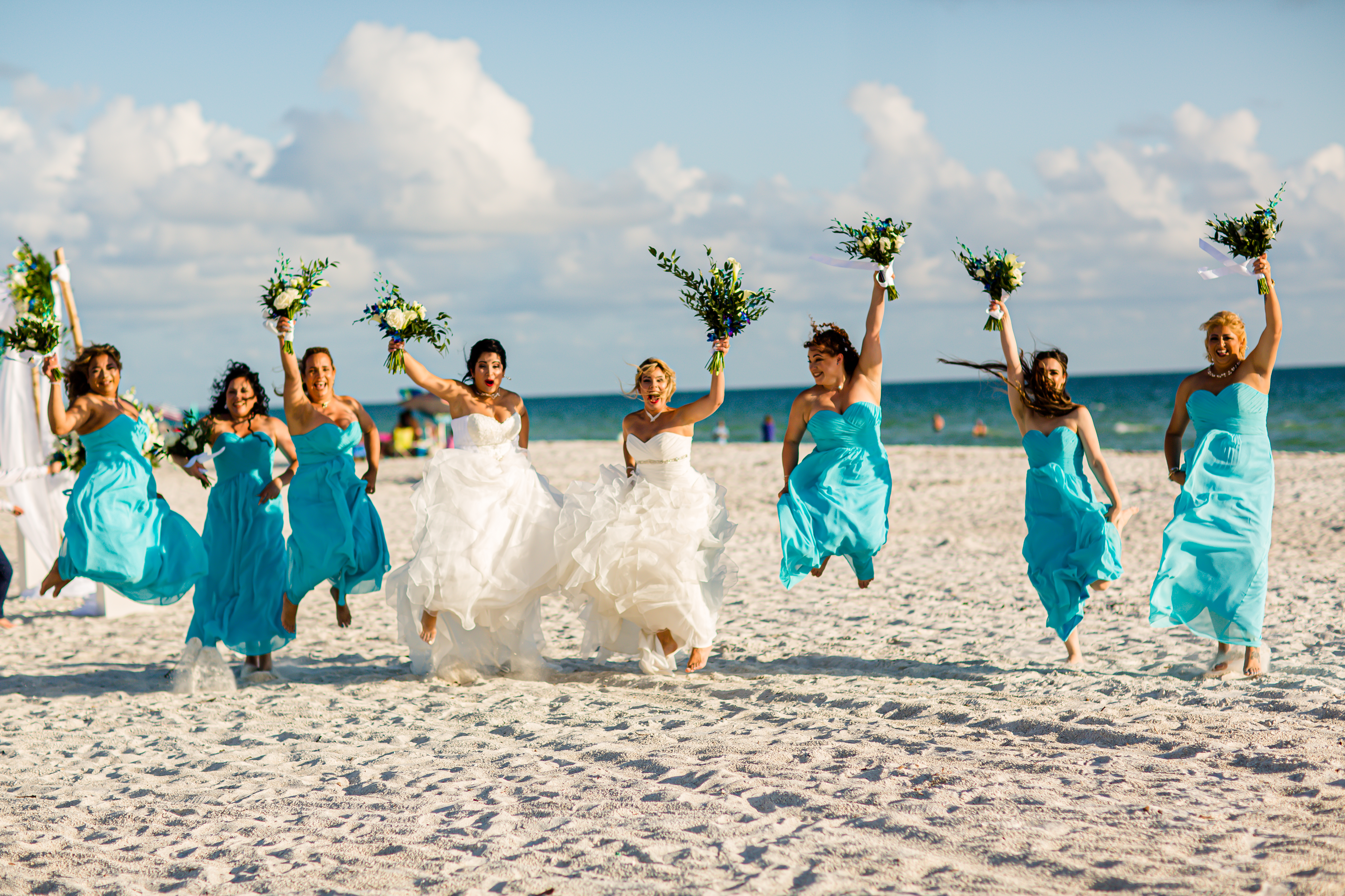 bridesmaids in bright blue dresses for beach wedding