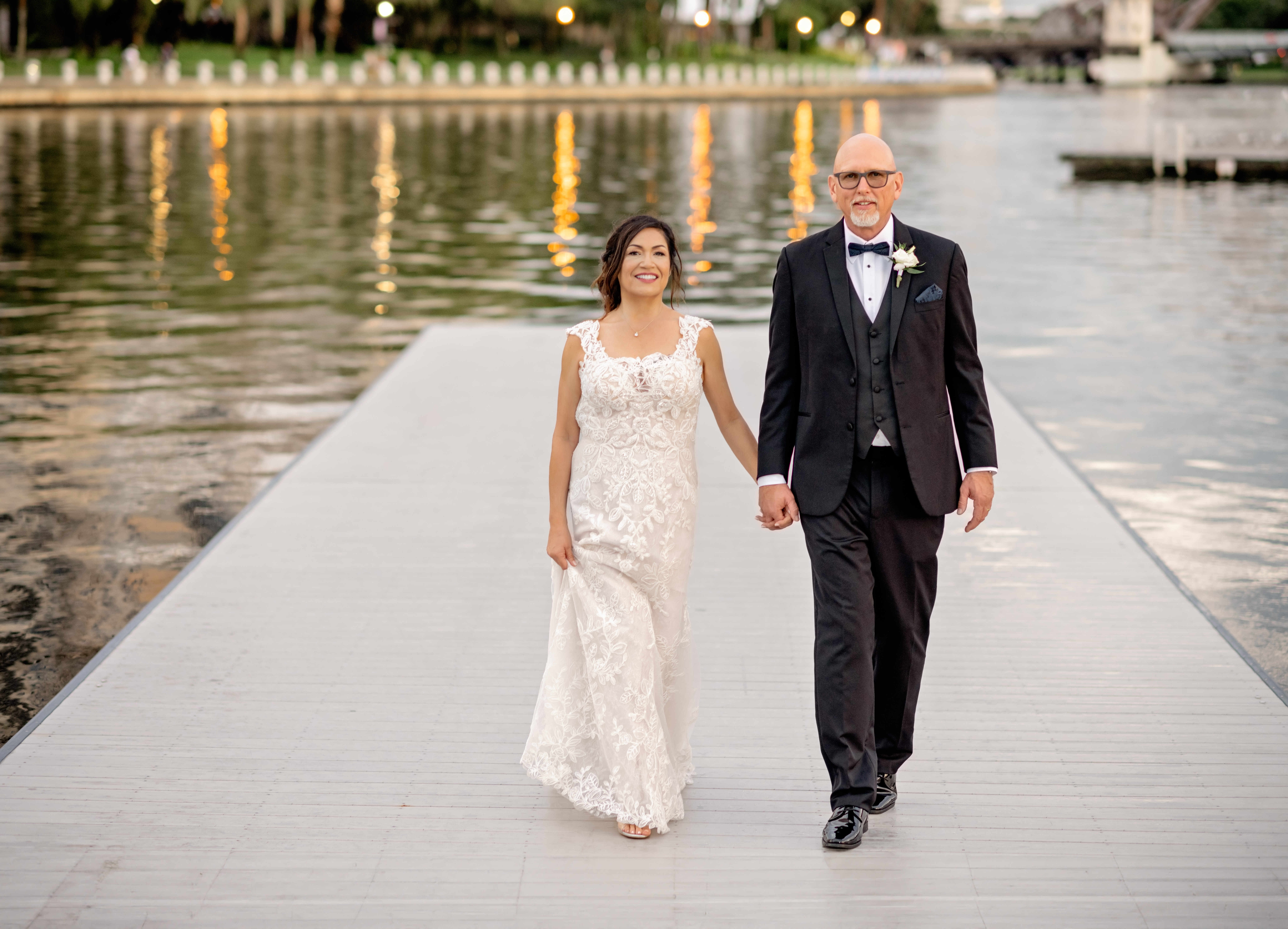 bride in lace wedding gown and groom in black tux