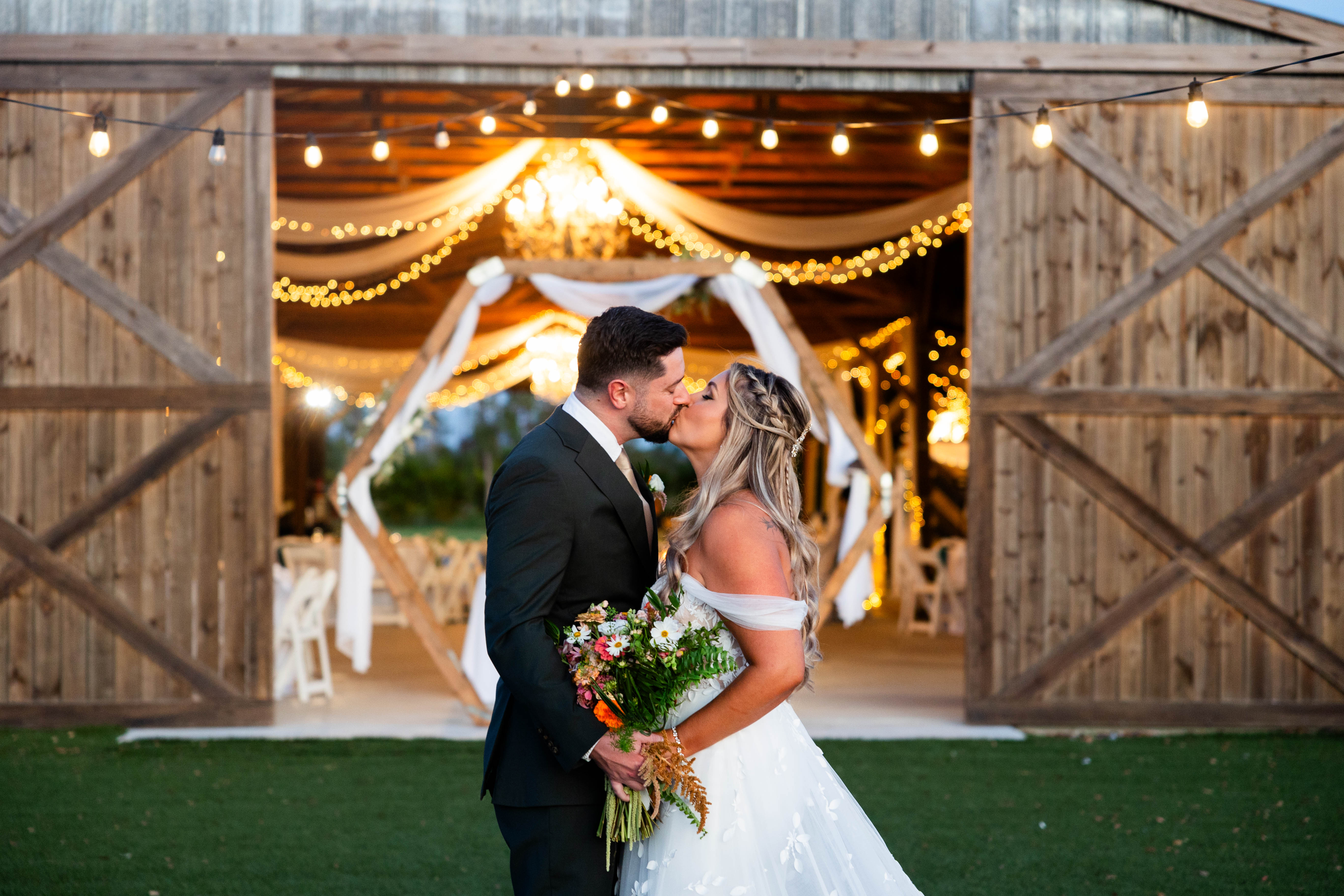 bride and groom portraits outside barn at Ivory Acres
