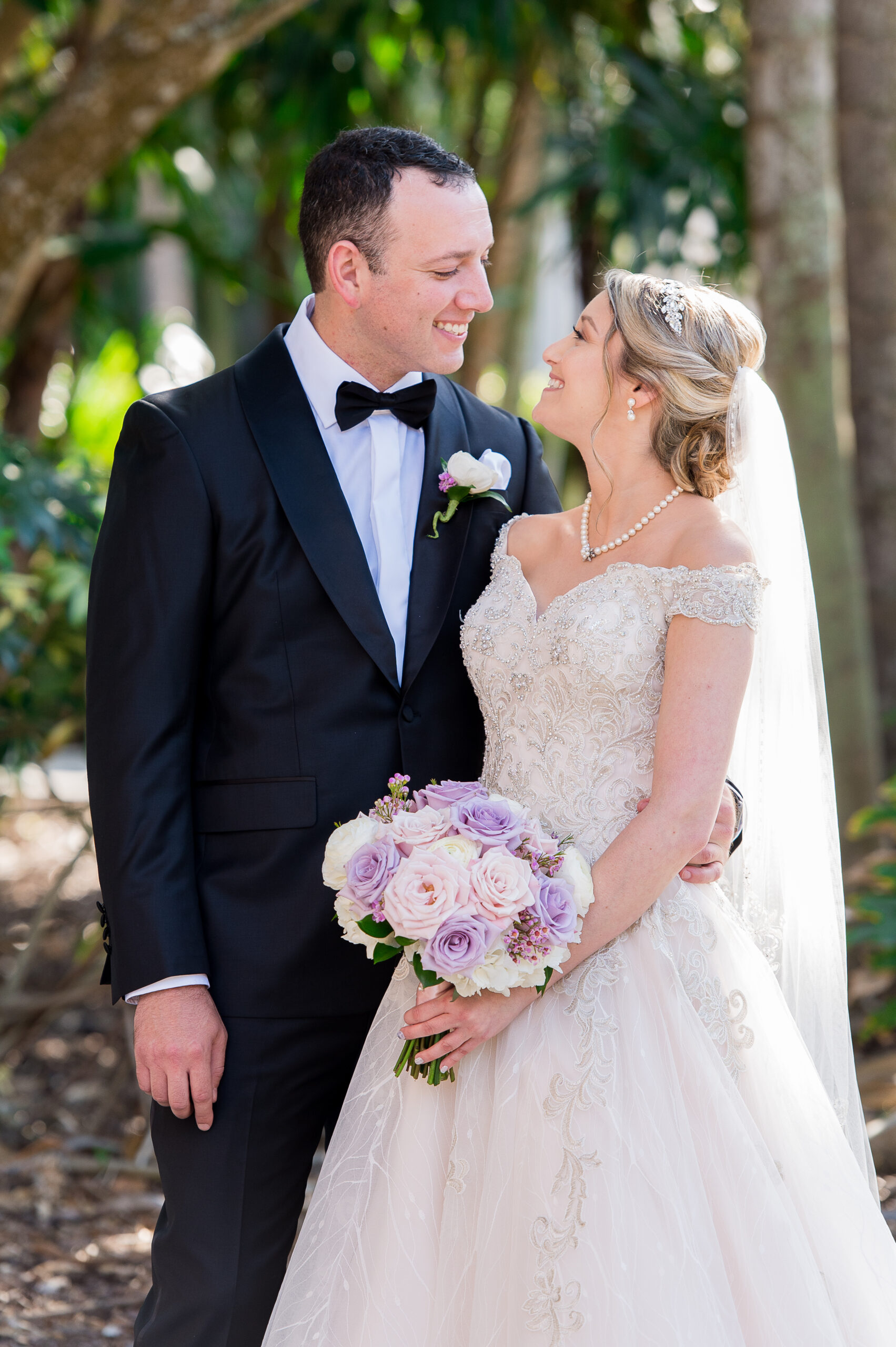 bride in embroidered wedding gown and groom in classic black tux