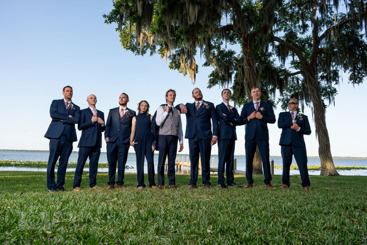 groomsmen in navy suits with wine colored ties