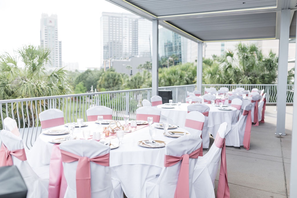 outdoor wedding reception at Tampa Bay History Center with pink details by Precious Moments Events